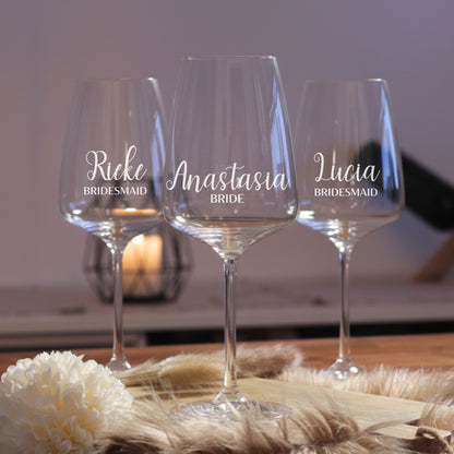 Personalisiertes Bridal Squad Weinglas Set mit gravierten Gläsern für Braut und Brautjungfern auf rustikalem Holztisch